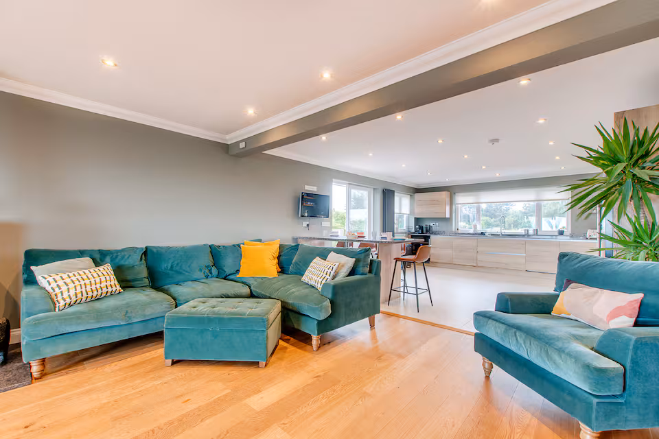 Spacious lounge flowing into modern kitchen with breakfast bar